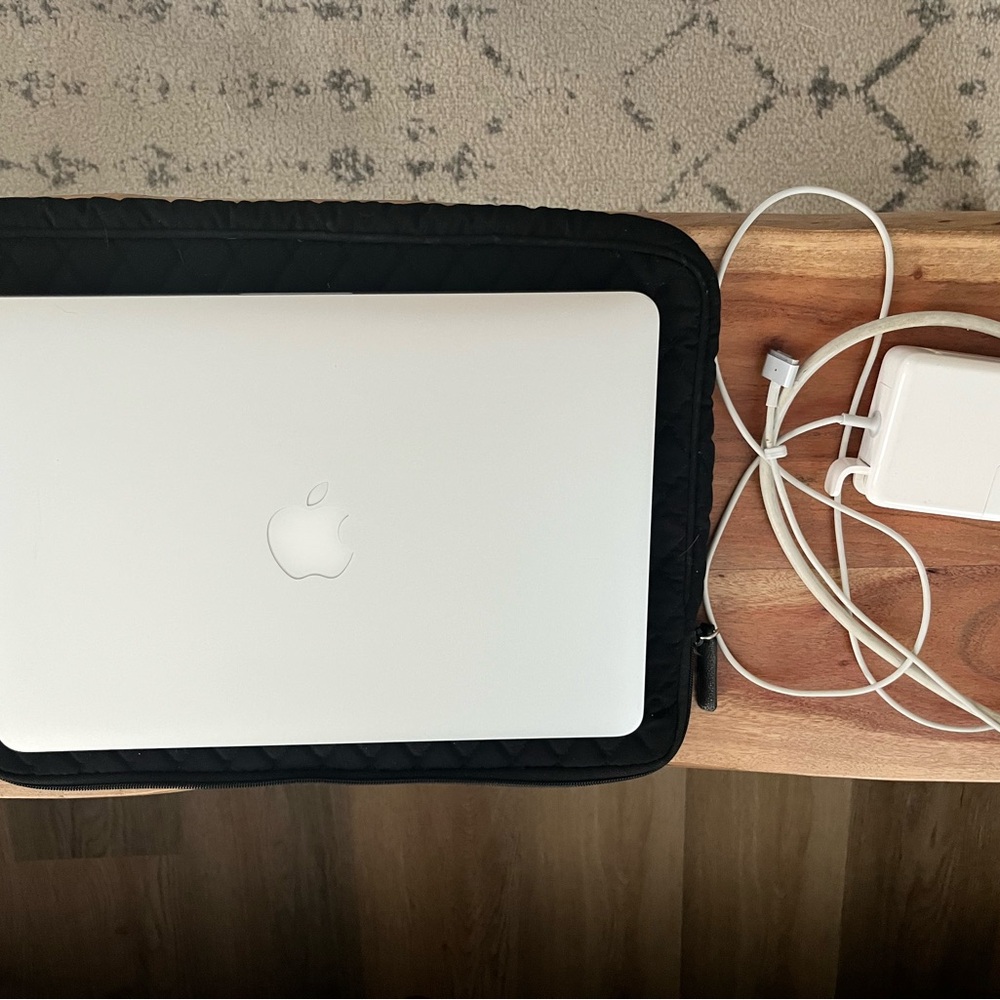 Apple Silver Laptop with Black Quilted Sleeve and White Charger